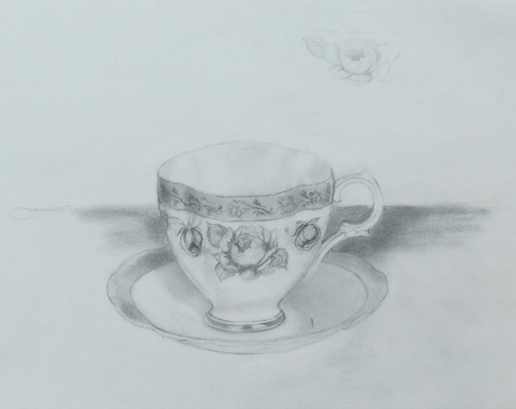 Graphite drawing of a rose-patterned teacup and saucer