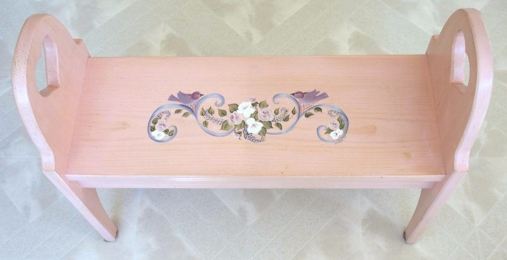 Pink folk art bench with hand-painted doves and roses on the seat