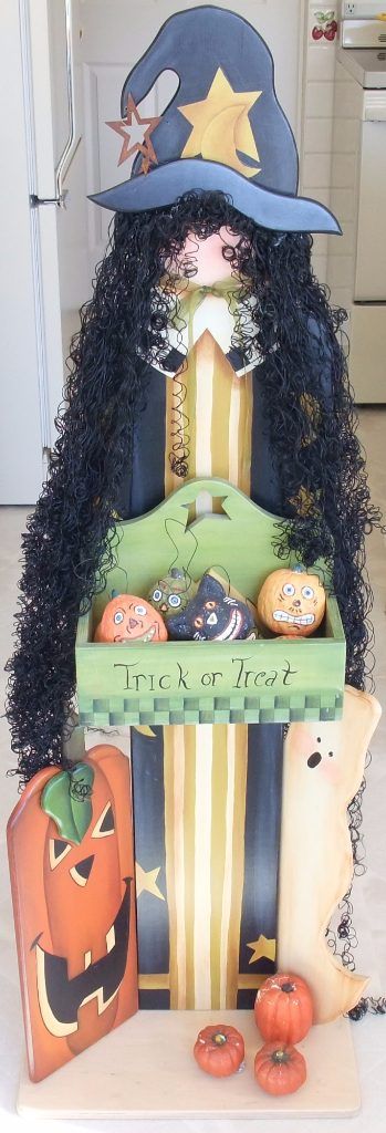 Tall folk art Halloween piece of a witch with a Trick or Treat box