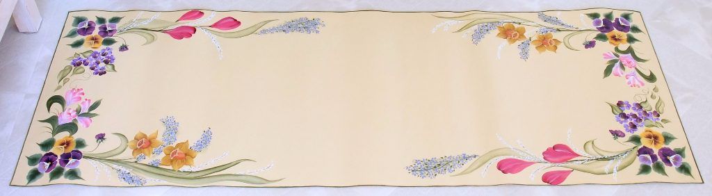 Folk art table runner hand-painted with sprays of tulips, daffodils, and pansies